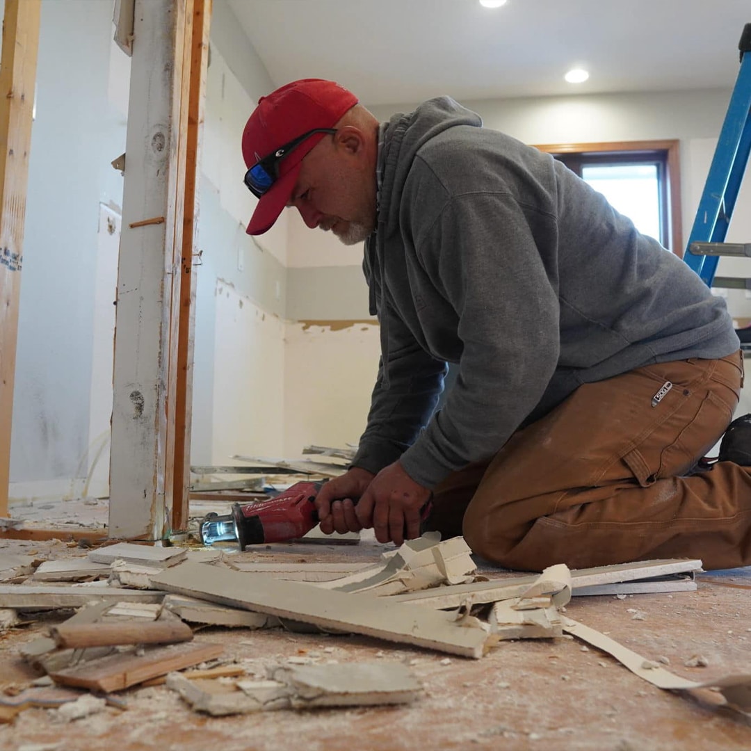 A contractor checking something on the floor