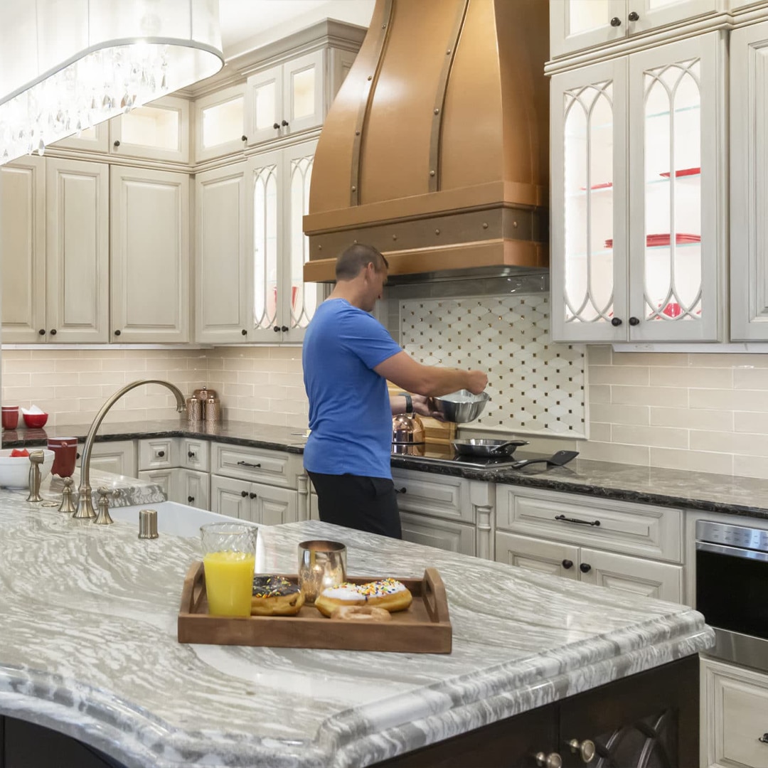 a man in a remodeled kitchen that availed Custom Countertops Elm Grove WI services