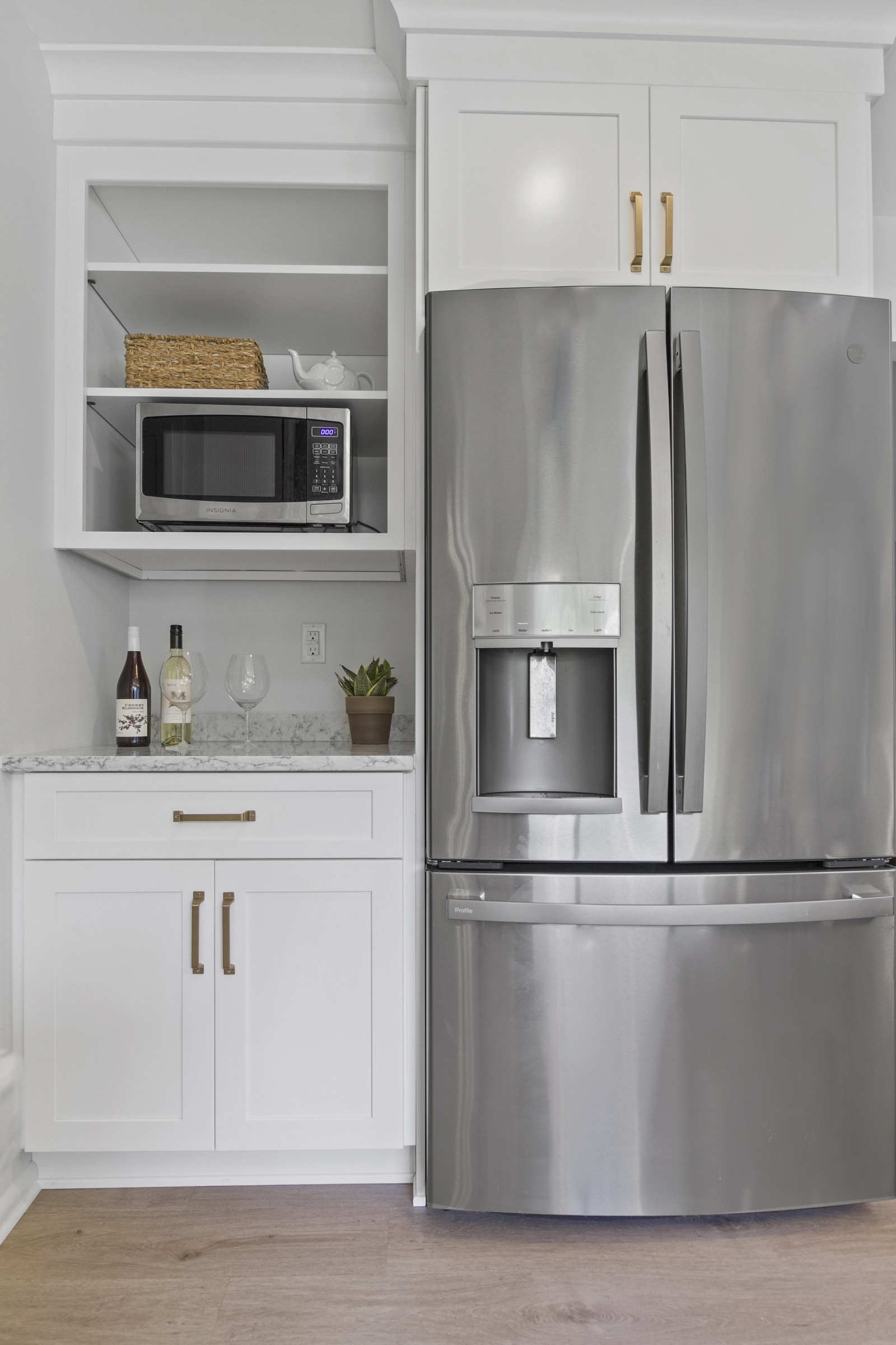 White kitchen remodeling with a refrigerator on the side